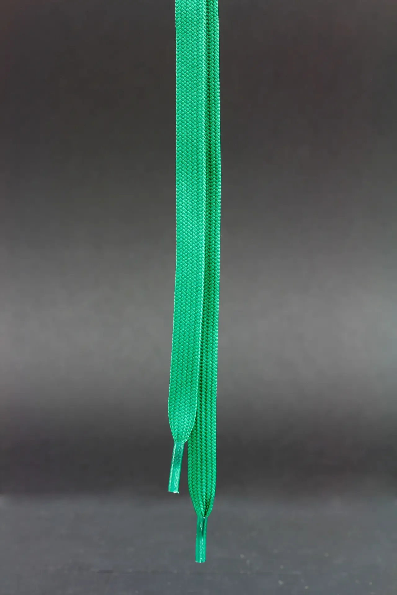 Green braided string ready for finishing