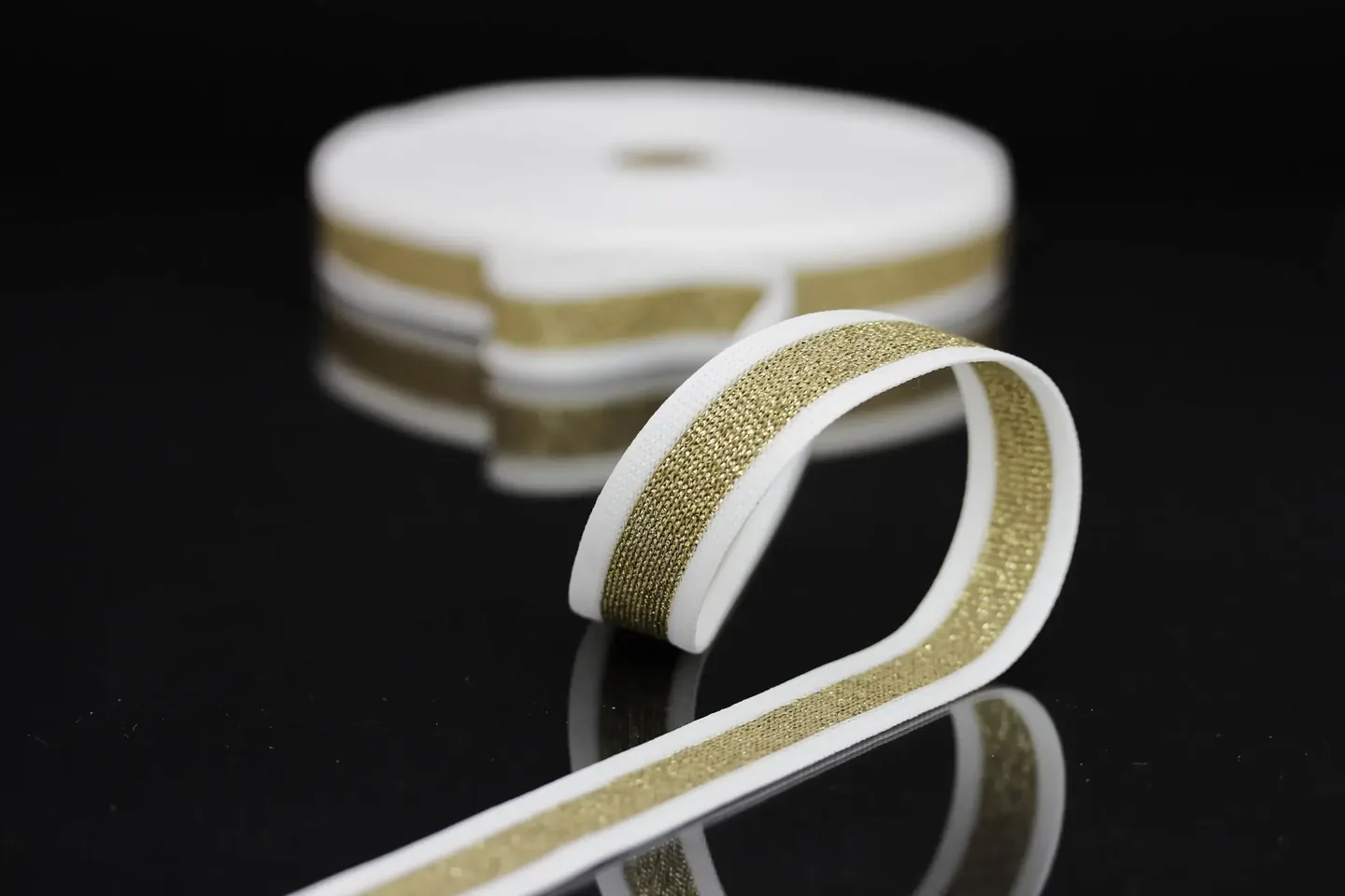 Bright textile webbing tricott arranged on a dark background